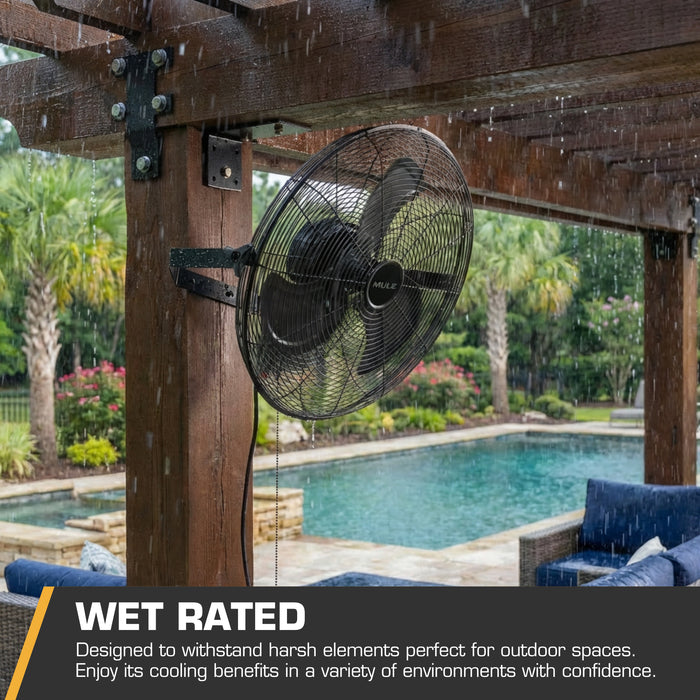 MULE Outdoor fan mounted on a wooden pergola with a pool and garden in the background