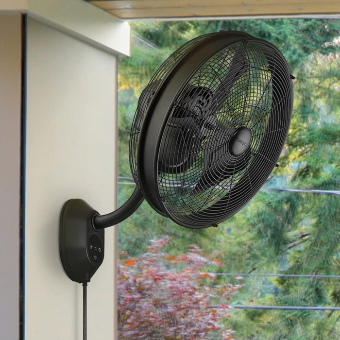 Wall-mounted Honeywell fan with a garden view in the background